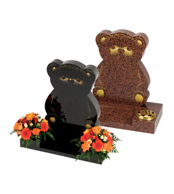 Black granite children’s headstone with carved bear shape and etched bear features.