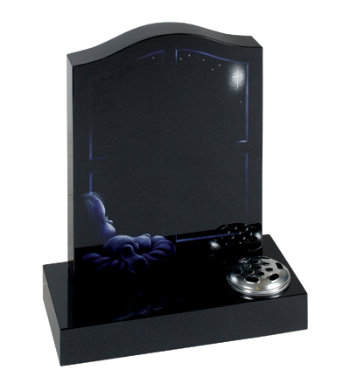 Black granite children’s headstone with etched design of a child sleeping.