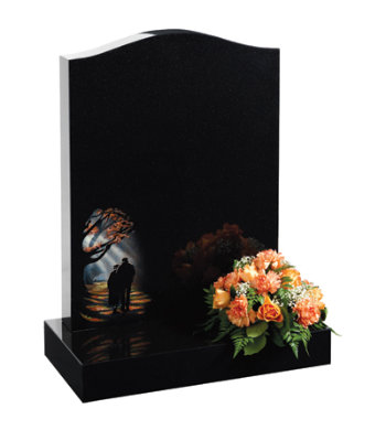 Black granite headstone with ogee top with decorative autumnal design.