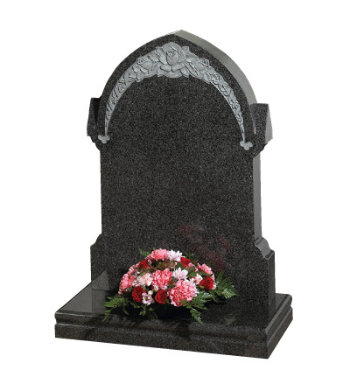 South African dark grey granite headstone of gothic shape with floral carving.