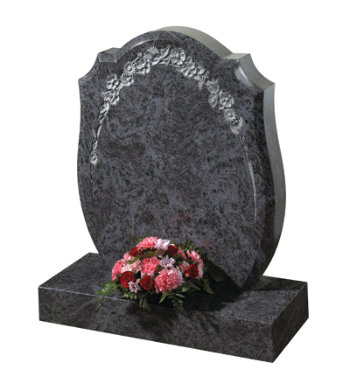 Lavender blue granite headstone with large bowed profile and floral carving.