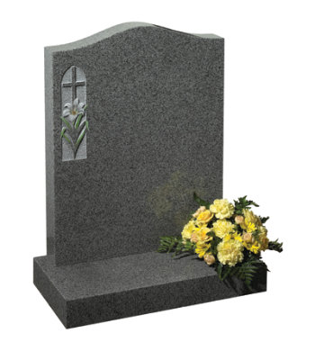 Karin grey granite headstone of ogee shape with cross and flower carved in relief.